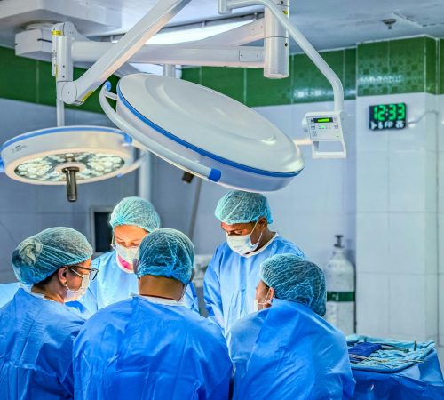 Doctors performing surgery in a sterile, brightly-lit operating room in Cebu City.